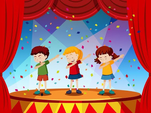 Three children on stage making a thanking gesture to the audience as colorful party poppers burst in the air, celebrating the end of a performance.